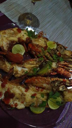 a plate of food on a table with a plate of food at Jardin Fleuri de Lety in Nosy Be