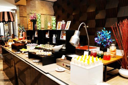 a buffet line in a restaurant with food on it at DoubleTree by Hilton Gurgaon New Delhi NCR in Gurgaon