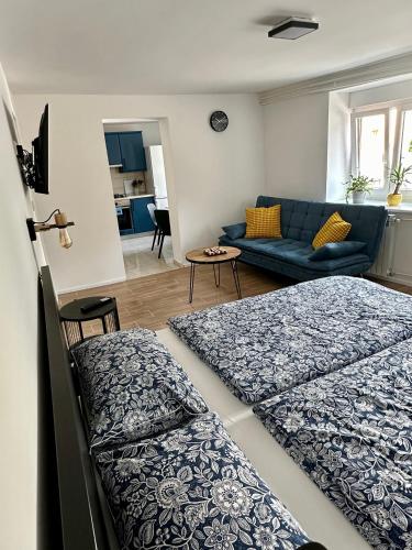 a living room with two beds and a couch at Alpine Echo Apartments in Bovec