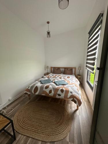 a bedroom with a bed with a rug and a window at Tiny retreat in Miercurea-Ciuc