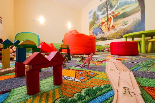 a child playing in a room with many play equipment at Dom Wypoczynkowy U Staszla in Bańska
