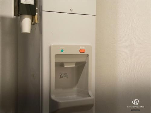 a bathroom with a urinal in a bathroom stall at Daiwa Roynet Hotel Chiba Ekimae in Chiba