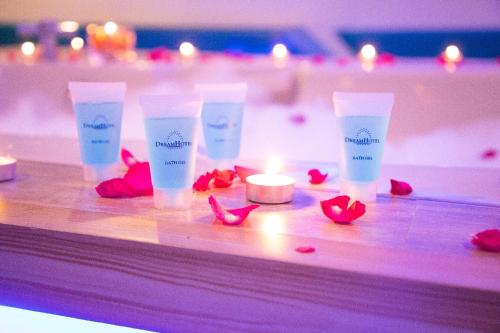 a group of three bottles of moisturizers and a candle at Hotel Dreamworld Las Pinas in Manila