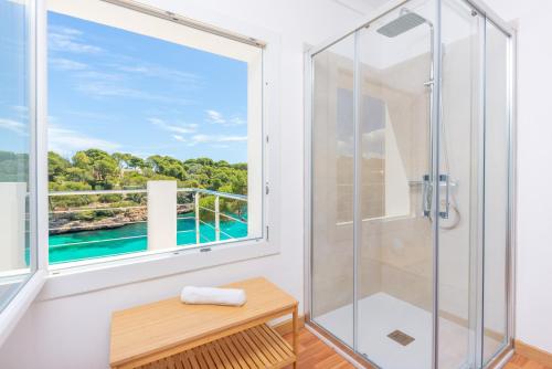 a bathroom with a shower and a window at Casa Ramon in Cala d´Or