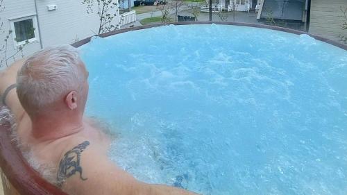 a man in a swimming pool with a shark tattoo at The perfect stop in Lødingen