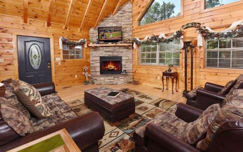 a living room with a fireplace in a log cabin at Hooked On Love in Sevierville