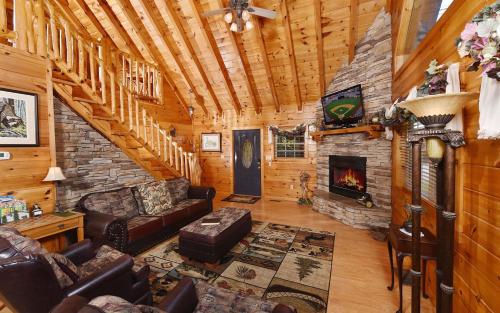 a living room with a fireplace in a log cabin at Hooked On Love in Sevierville