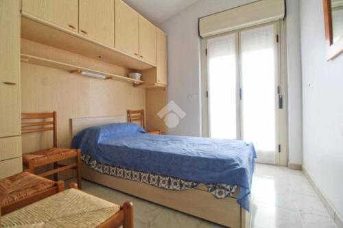 a bedroom with a bed and a large window at Villa Sofia in Botricello