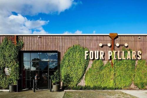 a building with a four pillars sign on it at Gloria of Healesville in Healesville