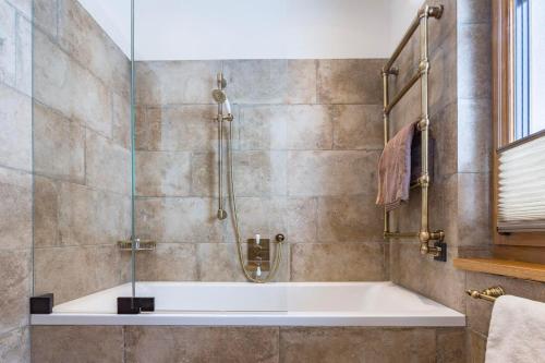 a bath tub in a bathroom with a shower at Alpenchalet Prinsengut in Hinterthal