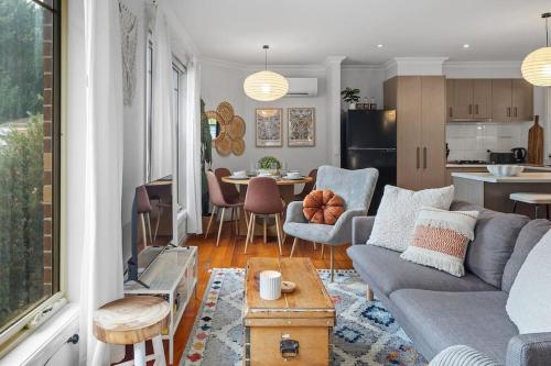 a living room and kitchen with a couch and a table at Gloria of Healesville in Healesville