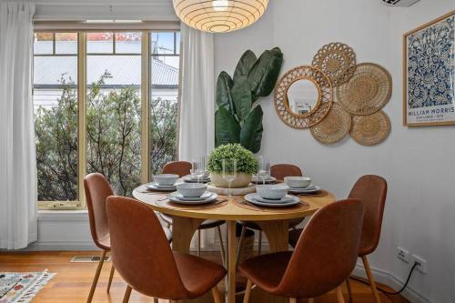 a dining room with a wooden table and chairs at Gloria of Healesville in Healesville