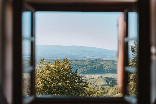 a view from a window looking out at a valley at Brunarica Dežno in Makole