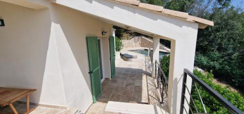 a white house with a green door and a walkway at Belvedere de Canaloro in Sari Solenzara