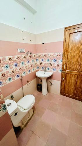a bathroom with a toilet and a sink at Hotel Ocean & Meadows Open Terrace ! Mall Road Hotel ! in Manāli