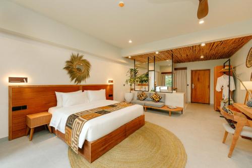 a bedroom with a large bed and a living room at Samawa Living in Paje