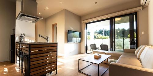 a living room with a couch and a table at Rakuten STAY MOTEL Nikko Kinugawa in Nikko