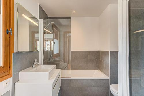 uma casa de banho com um lavatório e uma banheira em Les Melées Apartments - Alpes Travel - Argentiere em Chamonix-Mont-Blanc