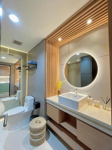 a bathroom with a sink and a mirror at The si Ndoro Suite Amarta Patraland Yogyakarta in Yogyakarta