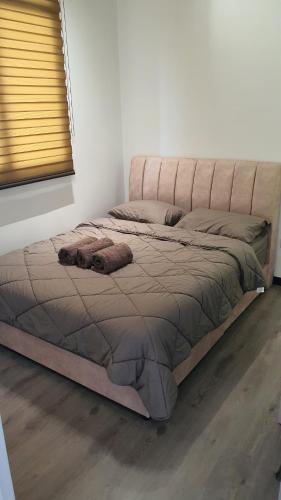 a large bed in a room with at Kami Tami Japandi Poolview in Putrajaya