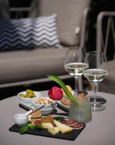 a table with a plate of food and glasses of wine at Hotel Sole in Cannero Riviera