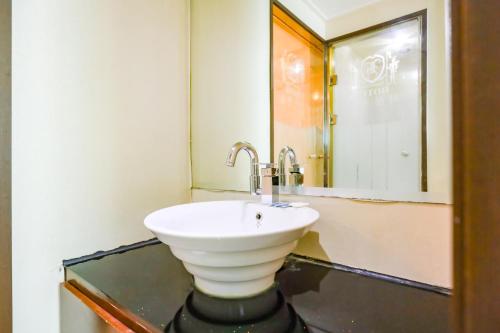 a bathroom with a sink and a mirror at Hotel Charlot Castle in Pyeongtaek