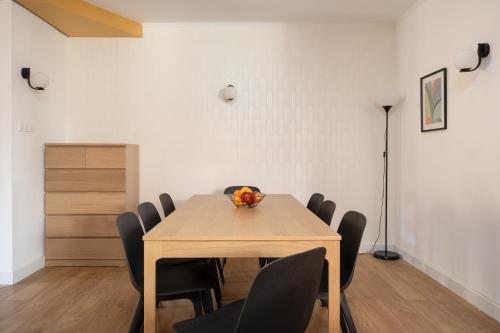 a dining room with a wooden table and chairs at LeoApart in Wrocław