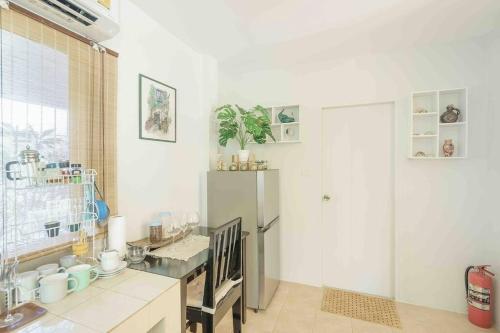 a kitchen with a refrigerator and a counter top at Sunset beach villa 7 O3 villas in Haad Pleayleam