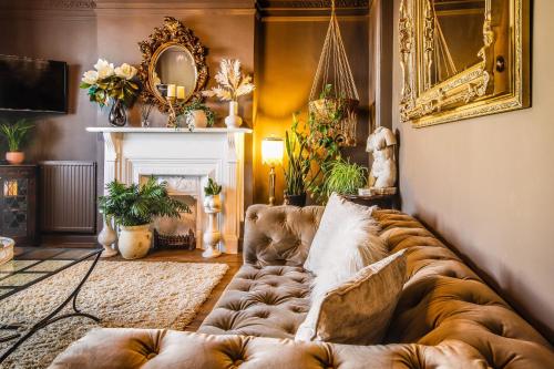 a living room with a brown couch in a living room at KIRA Beach Apartment, Hove Beach in Hove