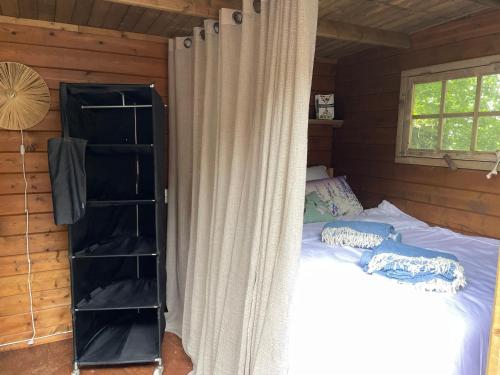 a bedroom with a bed in a wooden cabin at Luxury Experience in Off The Grid Lodge at an Amazing Lake Vinkeveense Plassen in Vinkeveen