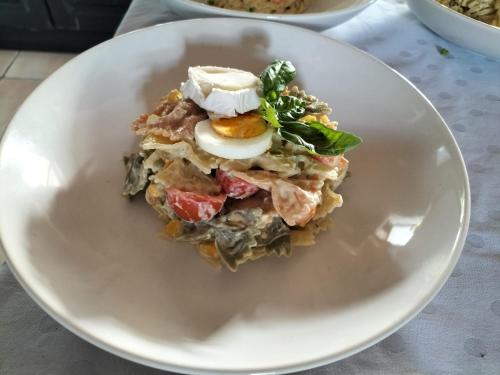 a plate of food with an egg on top at Bed & Breakfast Casa Ceratonia in Alora