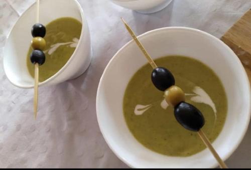 a bowl of soup with olives on top of it at Bed & Breakfast Casa Ceratonia in Alora