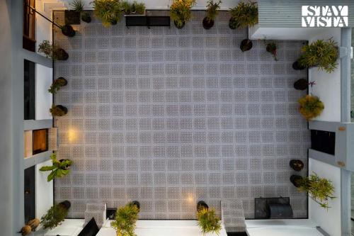 a room with a wall with plants on it at StayVista at The Alcove with Breakfast & BBQ Grill in Ooty
