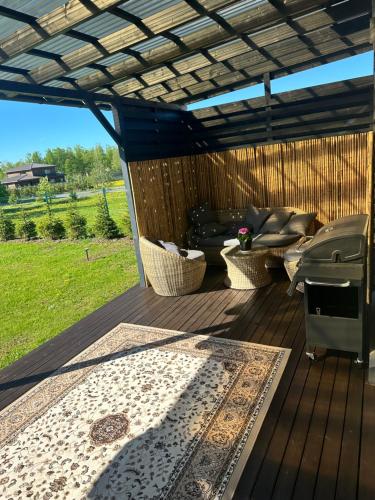 an outdoor deck with a couch and a table at Akihabara 1 in Loo