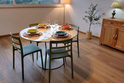 a dining room table with plates and wine glasses at Alloggio panoramico in Caprarola
