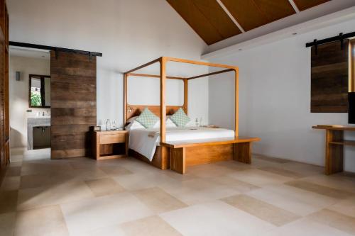 a bedroom with a canopy bed in a room at The Cove in Panwa Beach