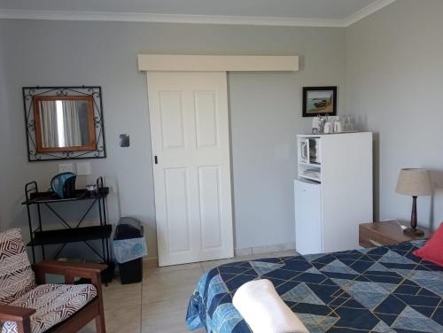 a bedroom with a bed and a white door at Olive's Nest 1 in Velddrif