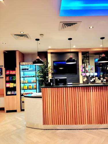 a bar in a store with a counter at Holiday Inn Birmingham North - Cannock by IHG in Cannock