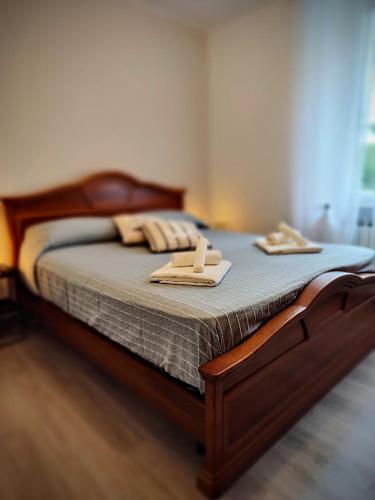 a bed with two towels on top of it at La Foce in Savona