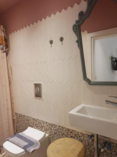 a bathroom with a sink and a toilet and a mirror at Studio Theotoki 2 in Corfu Town