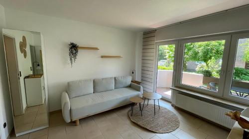 a living room with a couch and a window at Apartment am Stadtgarten in Norden