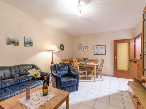 a living room with a couch and a table at Chiemgau Comfort D4 Ferienwohnanlage Oberaudorf mit Hallenbad und Sauna in Oberaudorf