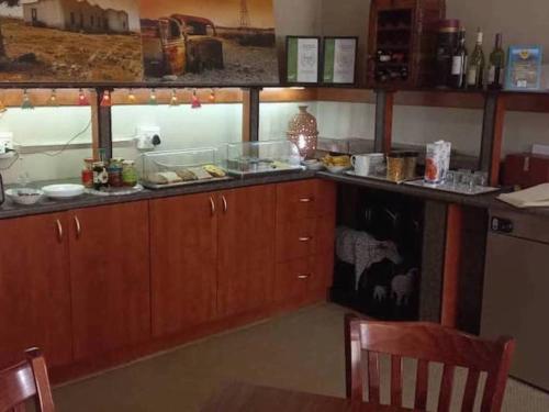 a kitchen with wooden cabinets and a counter top at Goibib Mountain Lodge in Grünau