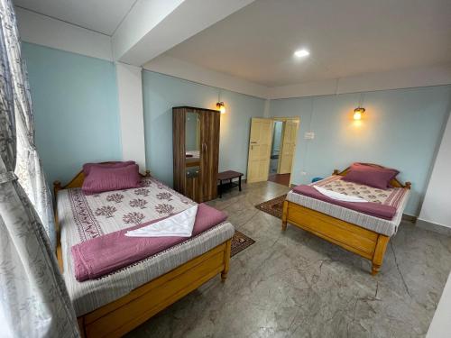 a bedroom with two beds in a room at Keeon Private Room Top in Shillong