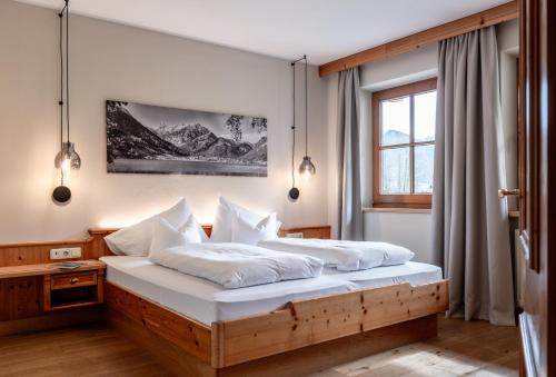 Postel nebo postele na pokoji v ubytování Sonnenhof Genusshotel & Appartements