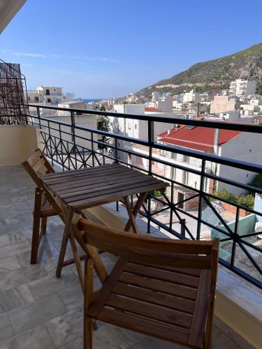a wooden bench sitting on top of a balcony at Adam's Luxury Studio in Loutraki
