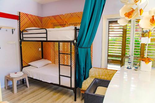a room with two bunk beds and a table at ENTER hostel in Kyrenia