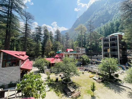 a view of a resort with buildings and trees at The Lalits Kitchen in Kasol