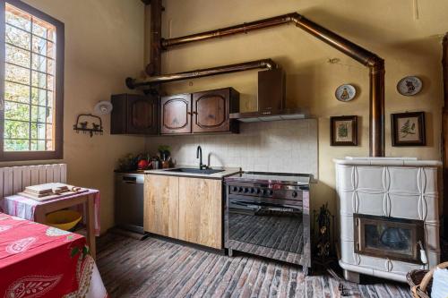 a kitchen with a stove and a sink at Scuderia Country Mansion 3300SquareFeet in Vanzo