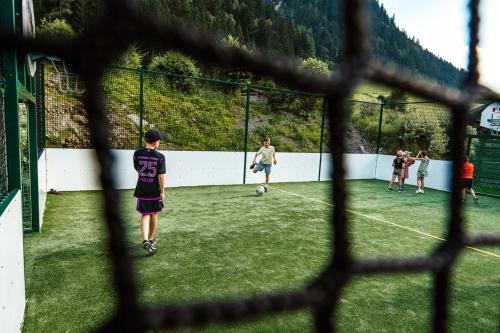 a group of people playing soccer on a field at Hotel Gasteigerhof in Neustift im Stubaital